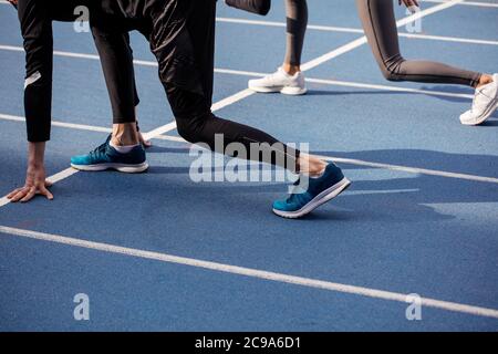 close up side view photo. sports people are going bto take part in the short sprint. side view cropped photo Stock Photo