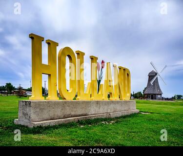 Sign and Dutch windmill at the entrance to the village of Holland, Manitoba, Canada Stock Photo