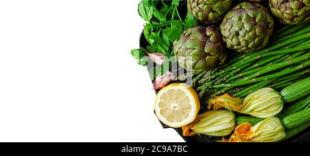 Green vegetables set of artichokes, asparagus, zucchini and persley isolated on white. Healthy eating Stock Photo