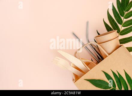 Plastic free set with bamboo, paper cutlery and drinking metal straws on pink background. Zero waste concept. Top view Stock Photo
