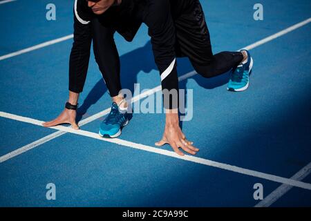 female is standing on the high start position. close up side view cropped photo Stock Photo