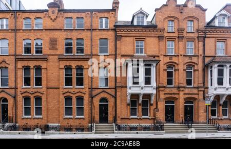The fine Victorian red brick buildings of Earlsfort Terrace Dublin, Ireland, erected in 1881 and named after John Scott, Baron Earlsfort. Stock Photo