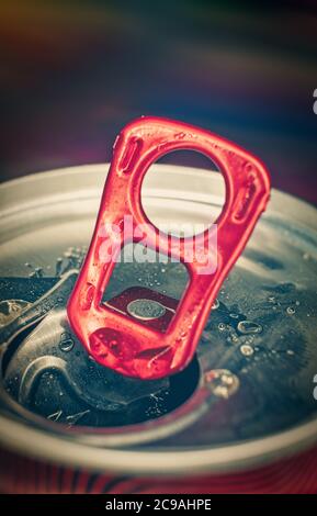 Macro photo of the lid of a can of fizzy drink open with the help of a ring-opener, shot with copyspace vertical image Stock Photo