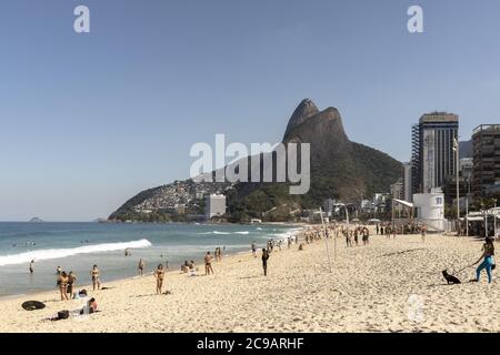 RIO DE JANEIRO, BRAZIL - Jul 19, 2020: Reopened Ipanema beach with the Two Brothers mountain during the COVID-19 Corona virus outbreak on a sunny midd Stock Photo