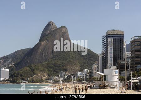 RIO DE JANEIRO, BRAZIL - Jul 19, 2020: Reopened Ipanema beach with the Two Brothers mountain during the COVID-19 Corona virus outbreak on a sunny midd Stock Photo