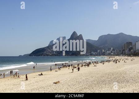 RIO DE JANEIRO, BRAZIL - Jul 19, 2020: Reopened Ipanema beach with the Two Brothers mountain during the COVID-19 Corona virus outbreak on a sunny midd Stock Photo