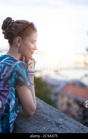 Young 20s urban adult woman daydreaming about love outdoors Stock Photo