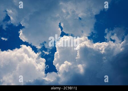 cumulus clouds high up in blue sky over head Stock Photo