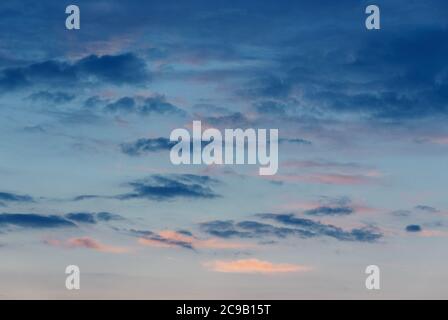 dark blue random clouds in evening sky, dusk sky background Stock Photo