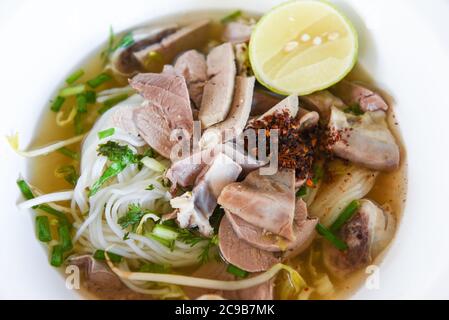 vermicelli noodles soup spicy with pork stew vegetable and lemon in bowl traditional thai and chinese style food of asia , Pork offal , Liver pork int Stock Photo