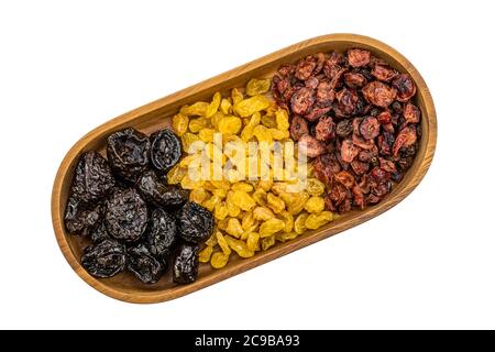 Top view of various kinds of dried fruit in a wooden tray on white background with clipping path. Stock Photo