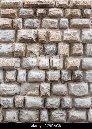 Background of antique wall made of hewn natural stone Stock Photo