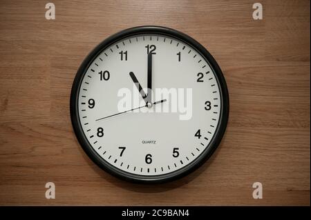 wall clock indicating the eleven o'clock hour Stock Photo