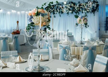 Close up of centerpiece at wedding reception. Luxury elegant table setting dinner in a restaurant Stock Photo