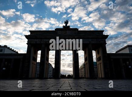 Berlin, Germany. 30th July, 2020. Clouds hang over the Brandenburg Gate in the early morning. Credit: Fabian Sommer/dpa/Alamy Live News Stock Photo