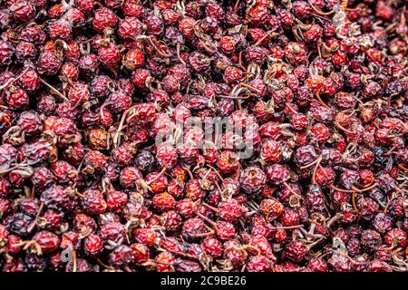 Solid background of fresh ripe and natural dried rose hips Stock Photo