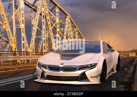 Electric BMW i8 Roadster on the old bridge during an evening storm Stock Photo