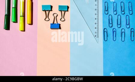School Supplies In Frame With Colorful Paper Background. School or office stationery on colorful background. Back to School. Copy space. Stock Photo