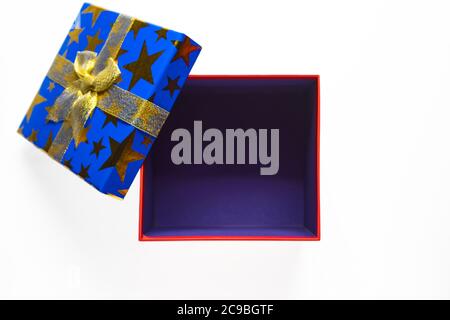 Gift or present empty box with golden ribbon on white background top view. Stock Photo