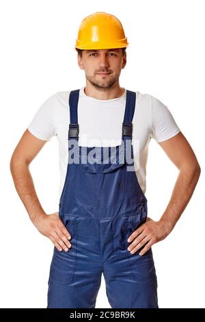 Young caucasian man construction worker in hard hat holding hands on waist isolated on white studio background Stock Photo