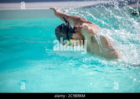Swimmer throwing hands out of the water Stock Photo