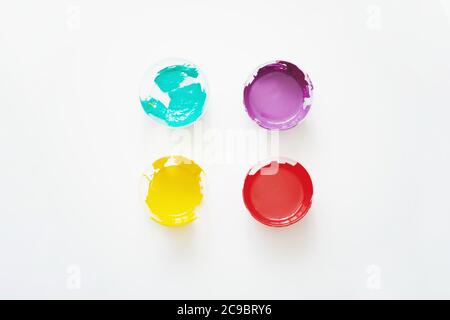 Paint cans abstraction. Background of renovation theme under yellow, red, purple Stock Photo