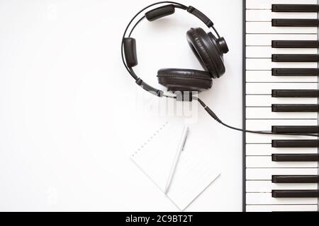 music template with keyboard synthesizer with headphone on white background. Stock Photo