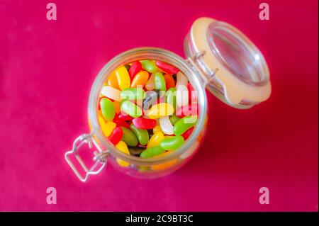 Jar full of colourful jelly beans sweets. Stock Photo
