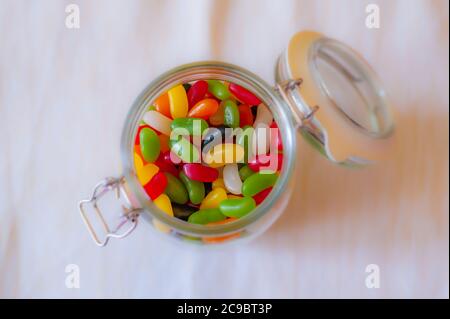 Jar full of colourful jelly beans sweets. Stock Photo