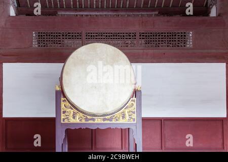 Traditional Chinese big drum on wooden frame with dragon relief in a temple, this traditional drum were usually pounded  in sacrificial rites or festi Stock Photo
