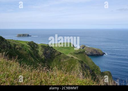 Seascape of the north coast of North Antrim in Northern Ireland, looking towards Sheep Island off Ballintoy with Carrick-a-Rede in the foreground Stock Photo