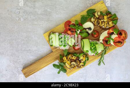 Great vegetarian appetizers with different toppings, top view. Flat lay of rye bread toasts. Stock Photo