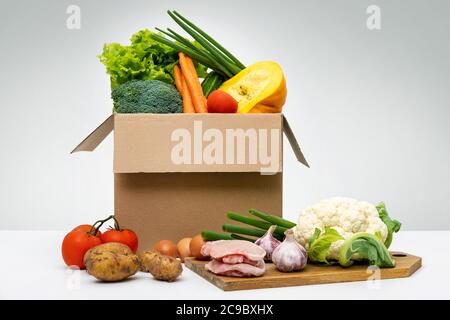 fresh organic local farm food - group of vegetables eggs and meat in cardboard box Stock Photo