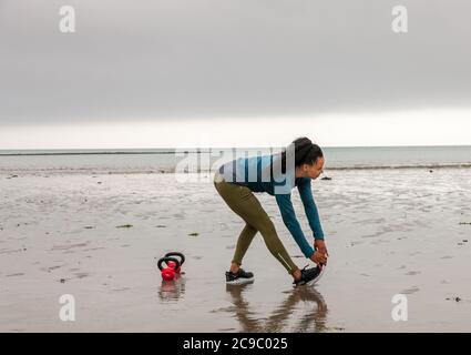 Shanagarry, Cork, Ireland. 30th July, 2020. Personel trainer Zoe McCurdy doing her early morning workout on Ardnahinch Beach near Shanagarry, Co. Cork, Ireland.- Credit; David Creedon / Alamy Live News Stock Photo