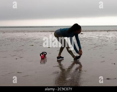 Shanagarry, Cork, Ireland. 30th July, 2020. Personel trainer Zoe McCurdy doing her early morning workout on Ardnahinch Beach near Shanagarry, Co. Cork, Ireland.- Credit; David Creedon / Alamy Live News Stock Photo