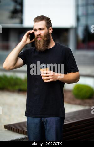 happy young man talk on phone and walk on street Stock Photo