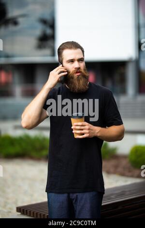 happy young man talk on phone and walk on street Stock Photo