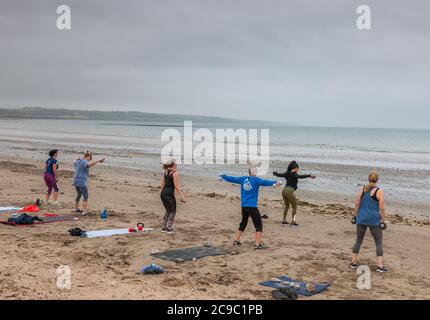 Shanagarry, Cork, Ireland. 30th July, 2020. Ladies from East Cork take part in an early morning workout under instruction from personal trainer Zoe McCurdy at Ardnahinch Beach near Shanagarry, Co. Cork, Ireland. - Credit; David Creedon / Alamy Live News Stock Photo