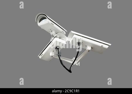 Three CCTV cameras on corner of building under restoration or renewal outdoors. Security cameras on wall of construction building at city street Stock Photo
