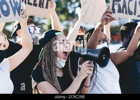 People from different ages and races protest on the street for equal rights - Demonstrators wearing face masks during black lives matter fight campaig Stock Photo