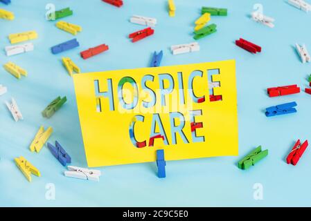 Text sign showing Hospice Care. Business photo text focuses on the palliation of a terminally ill patient s is pain Colored clothespin papers empty re Stock Photo