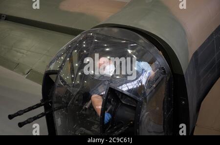 Preventive conservator Samantha Archetti cleans the rear gun turret of an Avro Lancaster Bomber at the Imperial War Museum Duxford as the attraction prepares to reopen to the public on Saturday following the easing of lockdown restrictions in England. Stock Photo