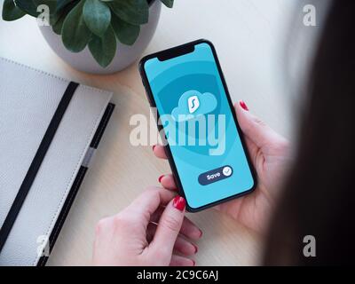 Woman holding a secured smartphone in her hands Stock Photo