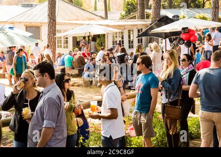 Johannesburg, South Africa - May 24, 2015: Crowds of diverse people sitting in the beer garden at outdoor farmer's market Stock Photo
