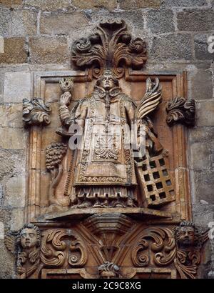 Saint Lawrence (225-258). Spanish martyr, deacon of Rome. Relief depicting Saint Lawrence holding the flame in his right hand and, in his left, the palm, the book and the gridiron. Facade of the Cathedral of Mondoñedo. Lugo province, Galicia, Spain. Stock Photo