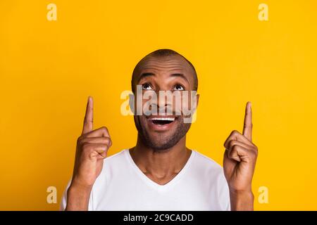 Close up photo of astonished crazy afro american guy indicate incredible ads sales discount point index finger copyspace wear casual style clothes Stock Photo