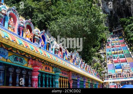 Beautiful natural limestone cave in Malaysia. Entrance to Dark Cave from a huge hollow feature. One of main caves located in Batu caves hill. Kuala Lu Stock Photo