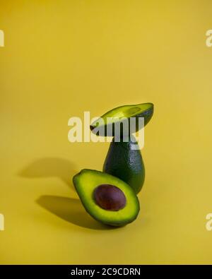 Close-up view of avocados isolated on yellow background Stock Photo