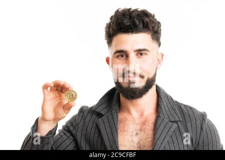 Young bearded stylish businessman holding bitcoin isolated on white Stock Photo