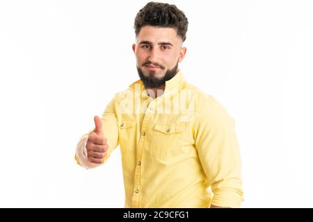 Young handsome man with beard over isolated white background with thumbs up Stock Photo